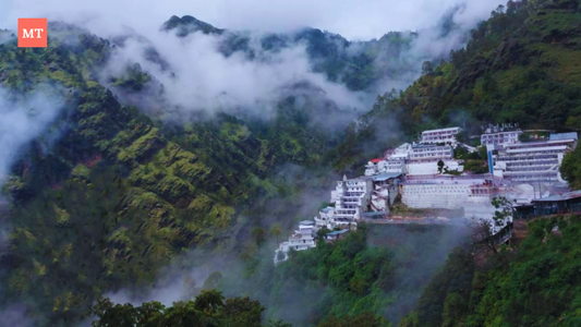 a building on a hillside with fog