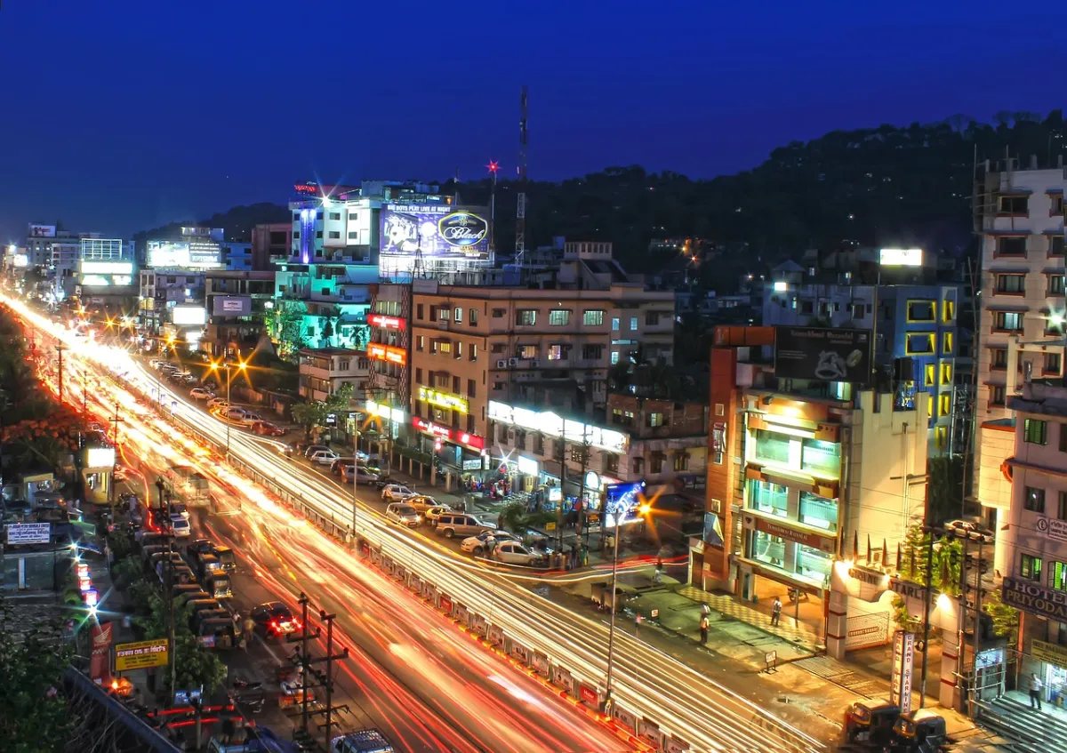 a city at night with cars and buildings, city name Guwahati