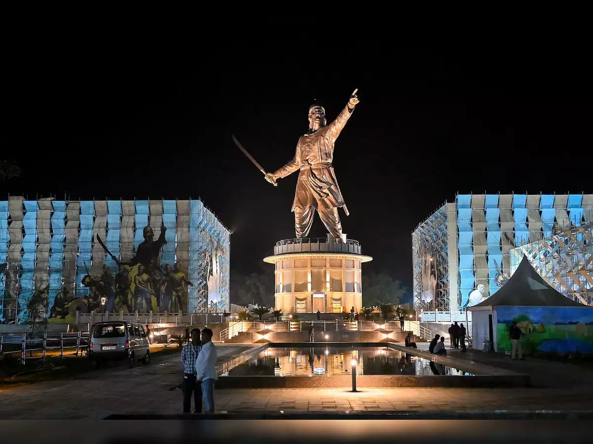 a large statue of a man holding a sword